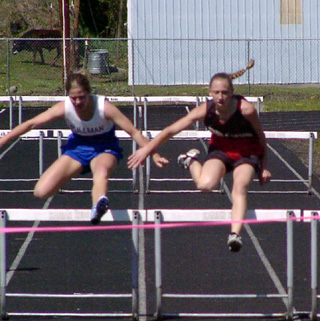 Tabitha Sonnen has a slim lead at the last barrier in the 300 hurdles. She wound up winning.