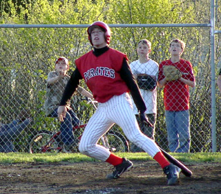 Jake Riener watches as he hits a long fly ball foul.