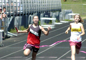 Vanessa Sonnen beats the Kamiah runner to the tape in the 4x100 relay.