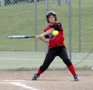 Kayla Holthaus connects against Grangeville. She had 3 hits in the game.