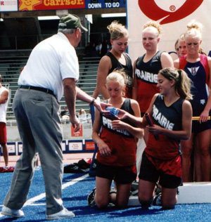 Members of the 4x100 relay team accept their 6th place medals.
