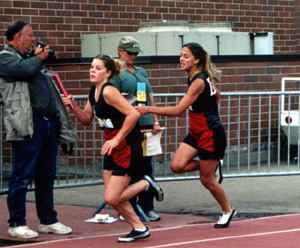Nicole Nida hands off the Kayla Uhlenkott in the 4x200 relay, which placed 4th.