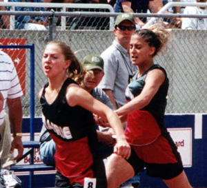 Nicole Nida hands off to Vanessa Sonnen for the final leg of the medley relay.