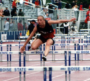 Tabitha Sonnen glides over a hurdle in the 100 hurdles event.