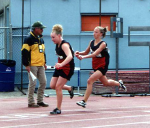 Tabitha Sonnen hands off to Lauren Merrill in the 4x200 relay.