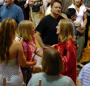 Sarah Forsmann congratulates graduate Angela Schumacher.