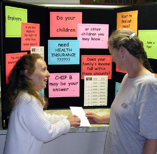 Jeanette Gorman, left, explains the CHIP B program to an interested parent.
