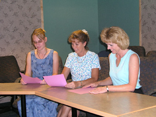 Mikki Bruegeman, Mary Beth Meyers and Delores Bowman, SMHC staff, look over school supply lists.