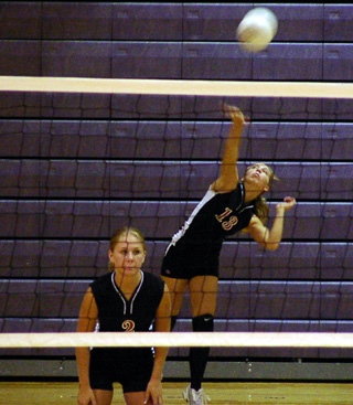 Vanessa Sonnen serves at Lewiston while Lindsey Crea gets ready for the serve return.