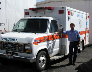 Tom Bower is shown with the old ambulance.