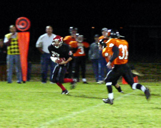 Jacob Holthaus makes a catch along the visitor's sideline.