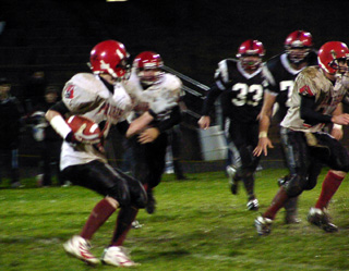 Phil Henry looks for an opening as he runs with the ball.