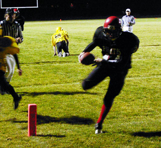 Kelby Wilson scores a touchdown. He broke a tackle attempt by the defender on the ground behind him.