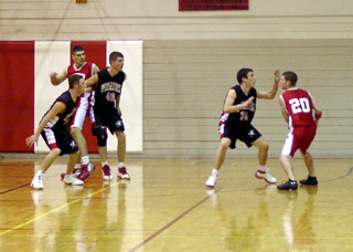 Kelby Wilson defends the ball while Kevin Funke and Chad Arnzen double team the post against C.V.