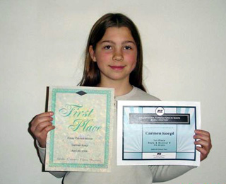 Carmen with her award certificates.