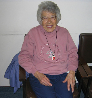 Mary Reed demonstrates the Health Watch personal response system.