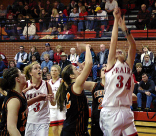 Brittny Behler shoots a lay-up as Briget Long looks on.