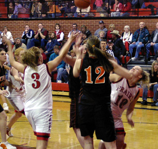 Briget Long reaches for a rebound as Meghan VanderPas looks on. Natalie Arnzen is in the background.