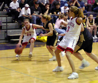 Ashley Jackson looks to drive the baseline while Briget Long posts up.