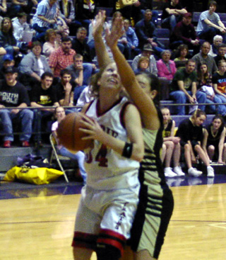 Brittny Behler tries to get a shot up against Highland.