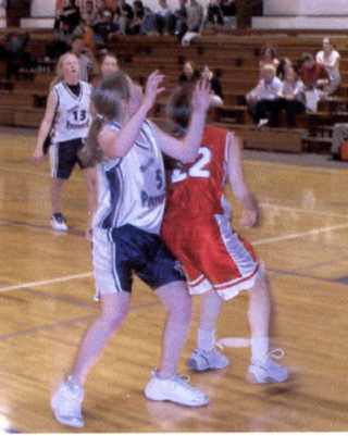 Lauren Wemhoff vies for a rebound. Her sister Cori is in the background.