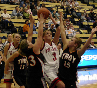Briget Long tries to put a shot up against Troy as Bridget Enneking looks on.