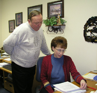 Larry Barker, CVH Clinics Manager and Theresa Uptmor, SMH Clinics Manager, review the new financial policy designed to reduce the bad debt incurred by both facilities and their clinics.