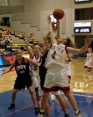 Bridget Enneking battles for the ball as Brittny Behler looks on.