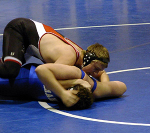 Logan Lustig starts to turn his opponent toward the third place winning pin.