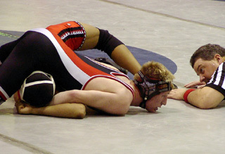 Shane Poxleitner goes for a pin against Worley's Steve Terry.