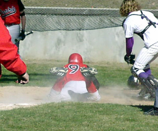 Chris Schumacher slides into home with the tying run against Kellogg.