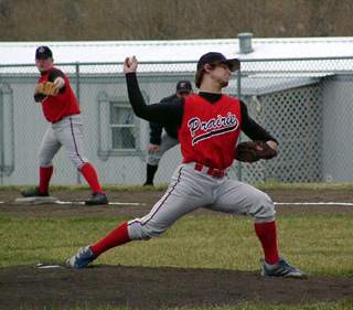 Dan Riener pitches as Eric Lerandeau holds the runner on at first.