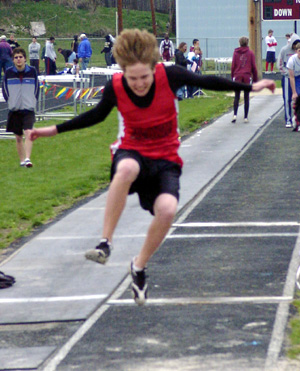 Jake Holthaus competes in the long jump.