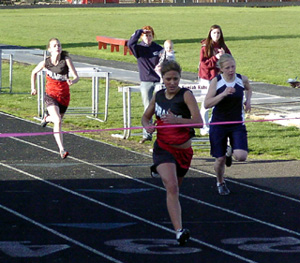Nicole Nida wins the 200 ahead of Summit's Cori Wemhoff, right, with Gina Holthaus in the background.