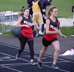 Randi Schumacher has just received the baton from Kayla Uhlenkott in the 4x440 relay.