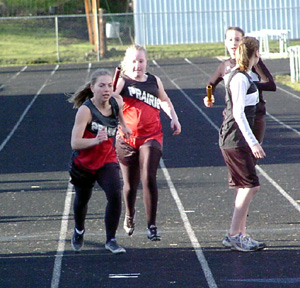 Lauren Merrill hands off to Vanessa Sonnen for the final leg of the medley relay.