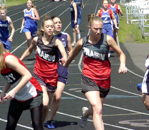 Gina Holthaus hands off to Tabitha Sonnen in the 4x200 relay.