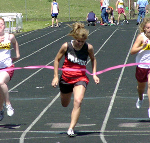 Nicole Nida breaks the tape to win the 100.