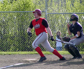 Eric Lerandeau and the Lewis County catcher watch his long fly head toward the left field fence.