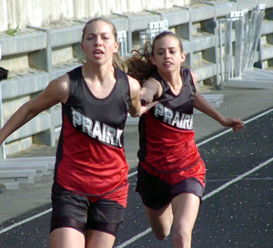 Gina Holthaus stretches to get the baton to Vanessa Sonnen in the medley relay.