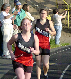 Kayla Lorentz takes off with the baton in the 4x400 relay after receiving it from Kayla Uhlenkott.