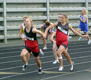 Nicole Nida hands off to Vanessa Sonnen for the final leg of the 4x100 relay.
