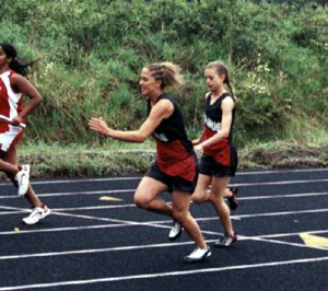 Gina Holthaus hands off to Nicole Nida at the midway point of the 4x100 relay.