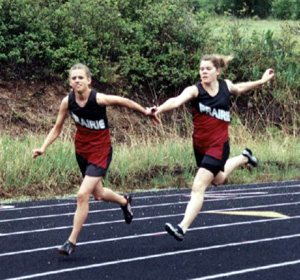 Kayla Uhlenkott reaches to get the baton to Gina Holthaus.