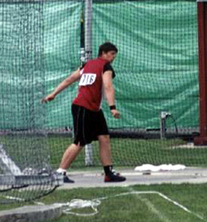 J.D. Riener follows through after letting the discus fly.