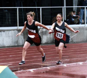 Casandra Schaeffer hands off to Kayla Uhlenkott in the medley relay.