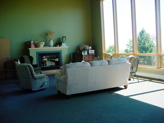 The upstairs lounge with a cedar board as the  mantle piece. The cedar was from a tree that stood where the center is now.