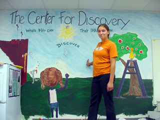 Jessma Barrani with the mural she has painted.