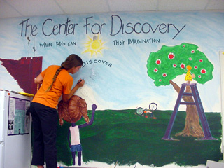 Jessma puts the finishing touches on her mural.