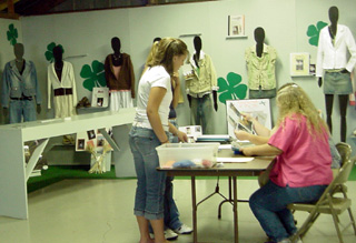 4-H clothing projects were being mounted for display.